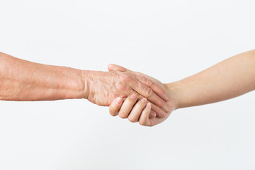 people, age and body parts concept - close up of senior and young woman holding hands