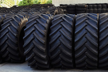 Tractor tires with a large protector, in a large warehouse of agricultural machinery.