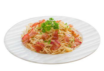 Spaghetti carbonara with bacon, cheese and chopped parsley on wood table in side view copy space on white isolated background with clipping paths. Italian traditional homemade food so delicious.