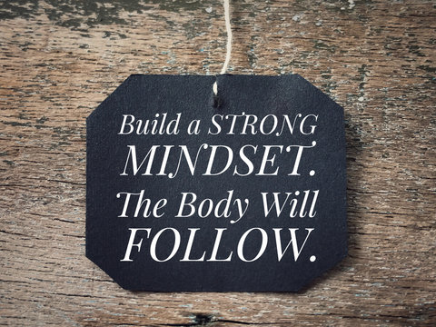 Motivational and inspirational quote - Build a strong mindset. The body will follow. With vintage styled background.