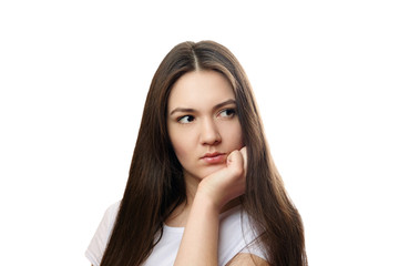 beautiful young woman on a white background, serious look, thinks, meditates