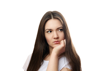 Fototapeta premium beautiful young woman on a white background, serious look, thinks, meditates