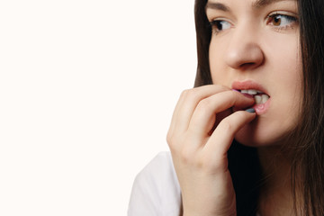 woman gnawing nails close-up, nervous, psychosis, white background