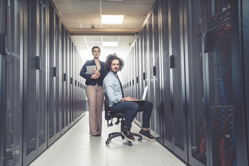 Fototapeta premium Man and woman working on servers at data center