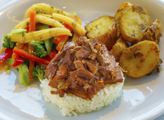 Turkish-style beef ribs served with rice, potatoes and garnish