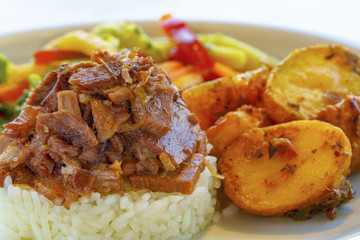Turkish-style beef ribs served with rice, potatoes and garnish