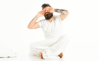 Hipster with beard and mustache waking up, sleepyhead.