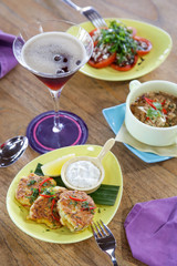 
Various dishes served on the table. Tuna croquettes with lemon dill yogurt, arugula salad with tomatoes and spanish lentil soup