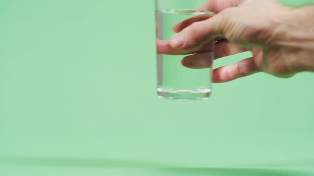 Taking a tall glass of water
