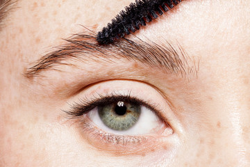 Close-up of female blue eye without make-up. Professional care for face concept. Master making...