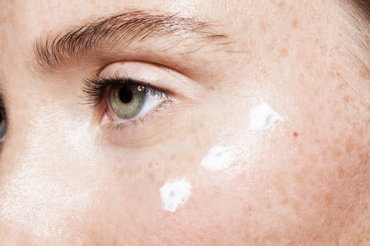 Close up of woman's face with moisturizer