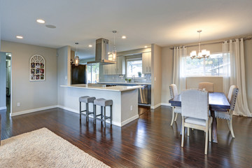 Open floor plan interior with shiny hardwood floor.