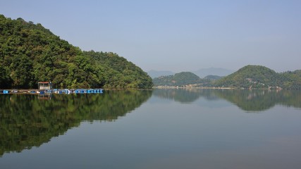 Fototapeta premium Green forest at the shore of lake Begnas, Nepal.