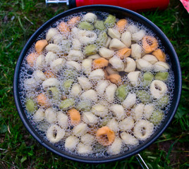 Tortellini in a boiling pot at the campsite