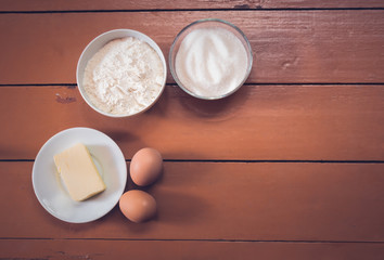 Kitchen ingredients on rustic painted wooden background. Top view with copy space.