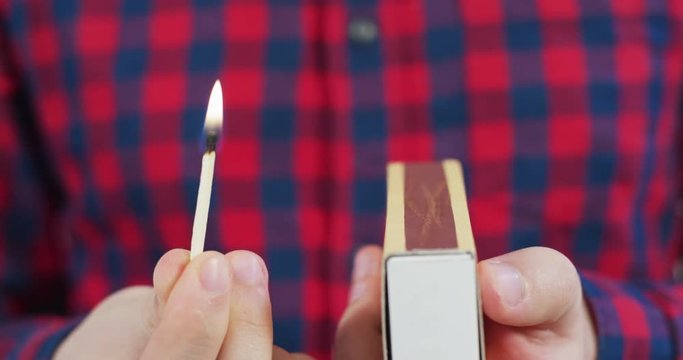 Holding a burning match
