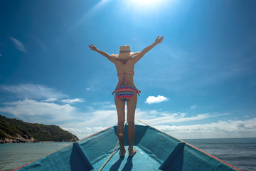 slim woman relax and enjoy the sea bystanding on the the prow of the local ferry boat bow, in holiday and long weekend vacation traveling in summer time