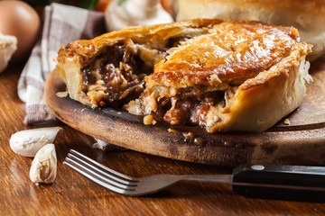 Fresh beef stew pie on a cutting board