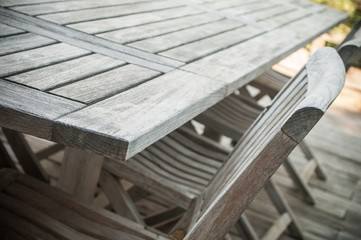 closeup of Teak garden furniture on a wooden terrace in spring