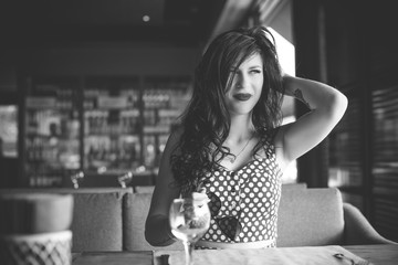 50s vintage style woman at restaurant. Pretty pin-up woman with make-up, vintage style in modern life 