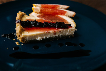 Cheesecake with grapefruit and chocolate on blue plate