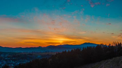 Panorama of the setting sun on the mountains in the summer. Gorno-Altaisk.