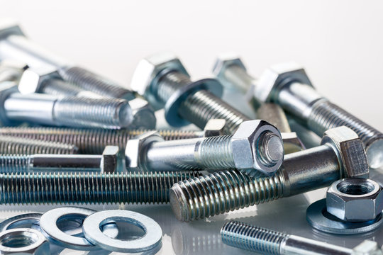 Screws, nut and bolts on white background.