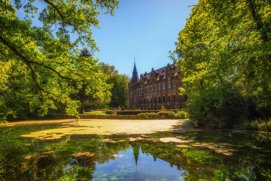 Castle Paffendorf in Bergheim with a pond in the sunlight