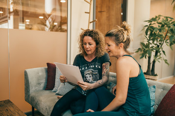 Two yogis discussing a paper 