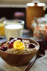 Oatmeal porridge with butter and cherry jam