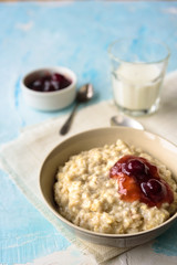 Oatmeal porridge with butter and cherry jam