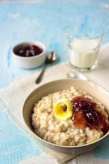 Oatmeal porridge with butter and cherry jam