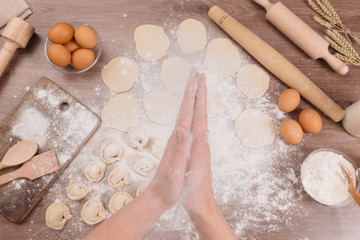 Preparing, cooking, making homemade ravioli, pelmeni or dumplings with meat, dough preparation for samsa.