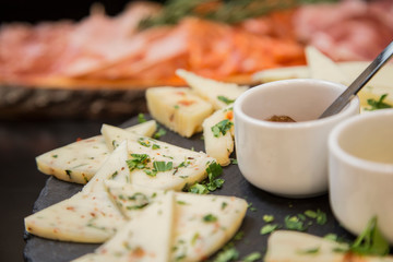 Traditional italian aperitif with proscioutto, mortadella sausage, cheese and aperol spritz drink