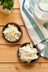 Top view, close up homemade cottage cheese in a bowl on old wooden table.