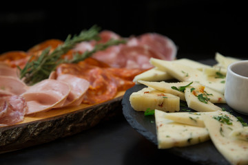 Traditional italian aperitif with proscioutto, mortadella sausage, cheese and aperol spritz drink