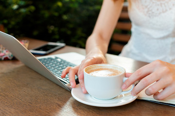 Woman using a laptop during a coffee break