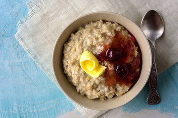 Oatmeal porridge with butter and cherry jam