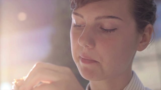 Close up of young woman eating food.