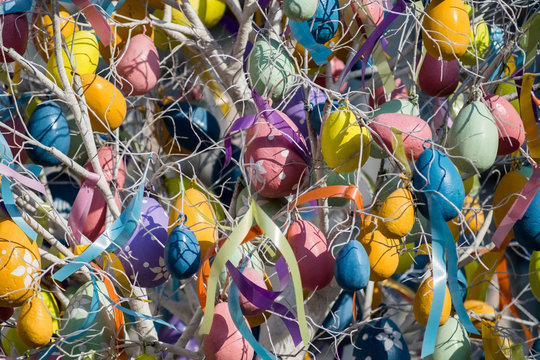 Photo of Easter tree with colorful eggs and ribbons