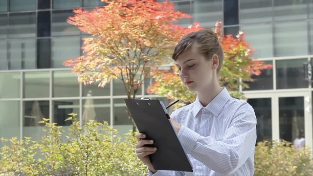Woman with Clipboard Taking Notes