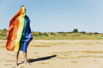 man covered with a rainbow flag