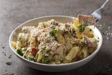 Italian pasta penne with chicken meat and bacon