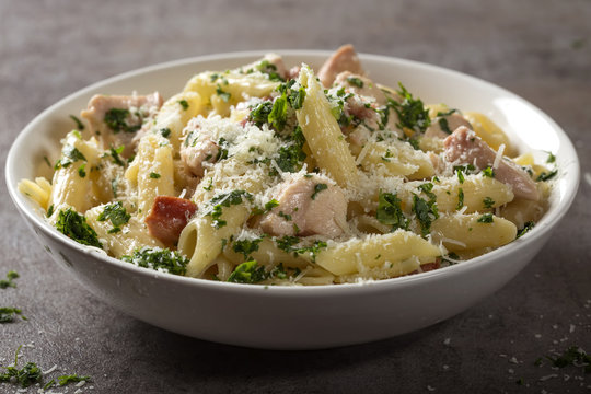 Italian pasta penne with chicken meat and bacon