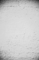 Grey painted wall with vertical lines. Old texture background. Small stains and holes.