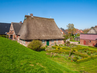 Fototapeta na wymiar croft with thatch roof in Haseldorf, Niederlbe, Schleswig Holstein, Germany, Europe