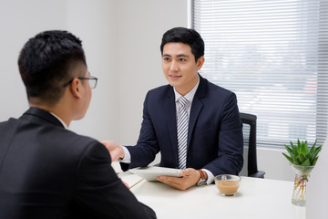 Job interview of two business professionals. Greeting new colleague