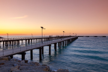 Fototapeta premium Sunset over the new and old Jetties at Rapid Bay South Australia on 13th May 2010