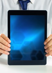 hands holding tablet with gradient screen