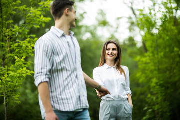 Romantic young couple walking and having fun in the park.